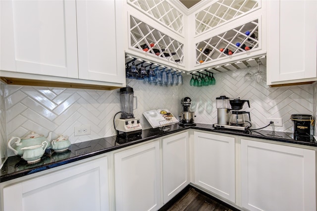 kitchen featuring dark stone counters, tasteful backsplash, and white cabinetry