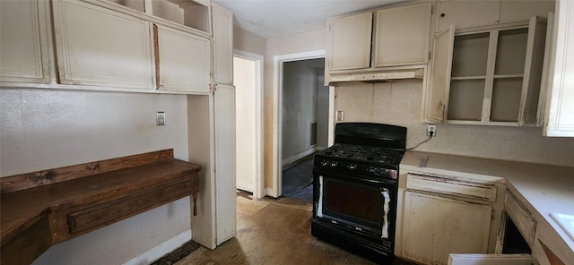 kitchen featuring black gas stove and concrete floors