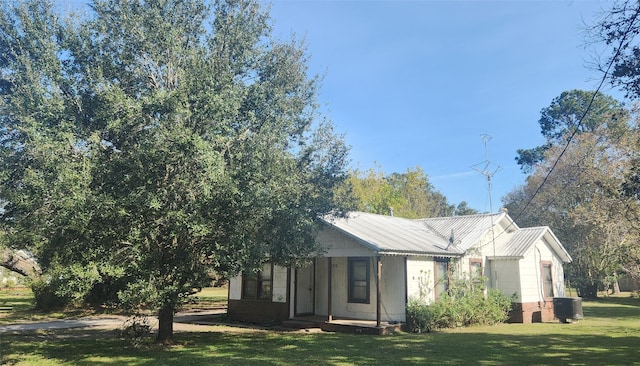 exterior space featuring a yard and central air condition unit