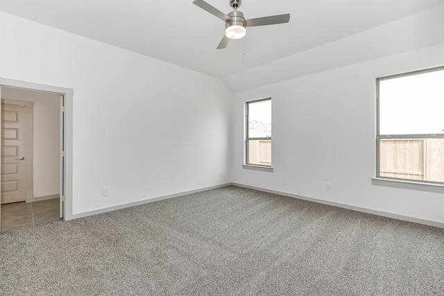 spare room with ceiling fan, carpet flooring, and vaulted ceiling