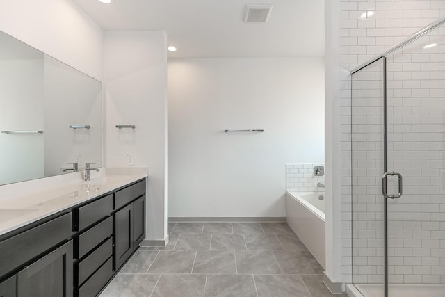 bathroom featuring vanity, independent shower and bath, and tile patterned flooring