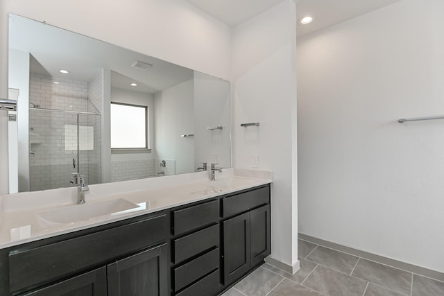 bathroom featuring tile patterned flooring, vanity, and a shower with door