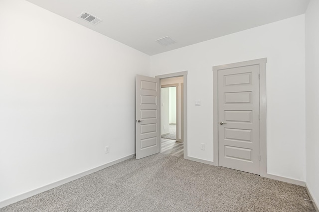 unfurnished bedroom featuring light colored carpet