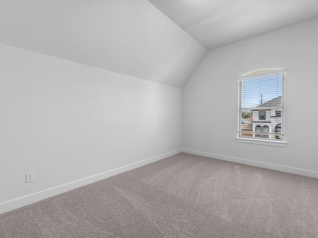 bonus room featuring lofted ceiling and carpet