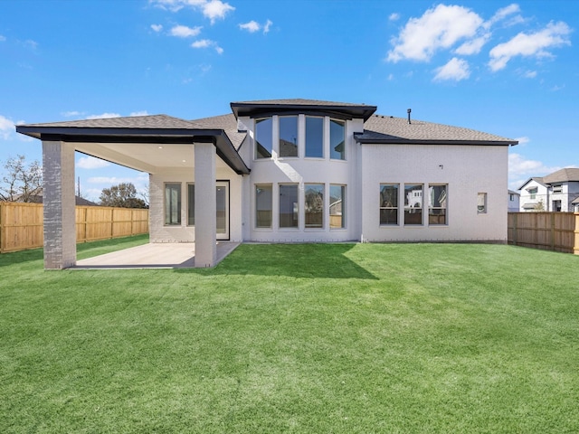 rear view of house featuring a patio and a lawn