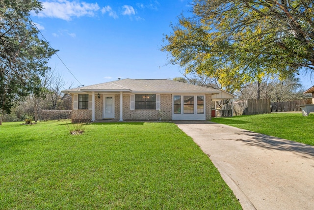 ranch-style house with a front yard and a carport