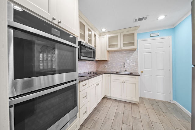 kitchen with sink, backsplash, and appliances with stainless steel finishes