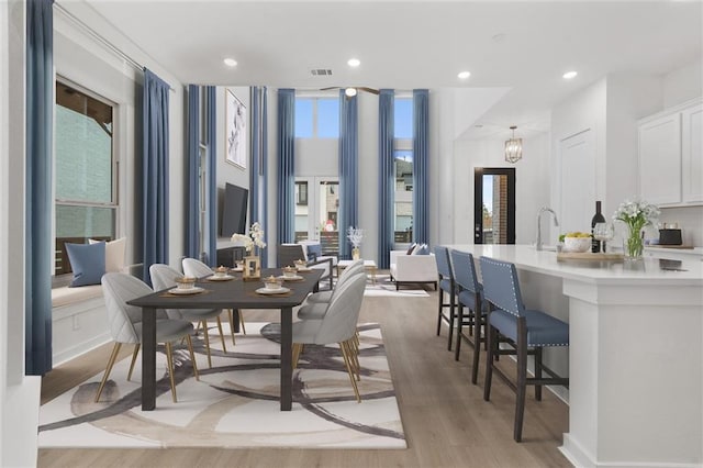 dining room featuring sink and light wood-type flooring