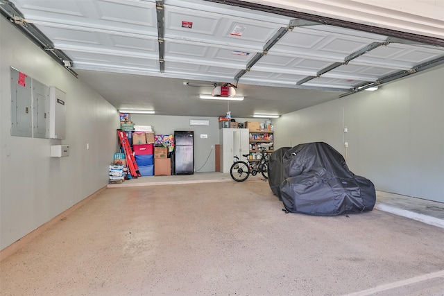 garage with electric panel and a garage door opener