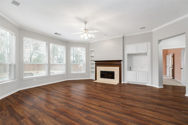 unfurnished living room featuring visible vents, crown molding, dark wood-type flooring, and a fireplace with flush hearth