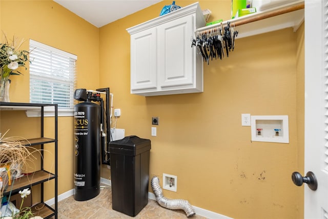 washroom featuring cabinet space, hookup for a washing machine, electric dryer hookup, and baseboards