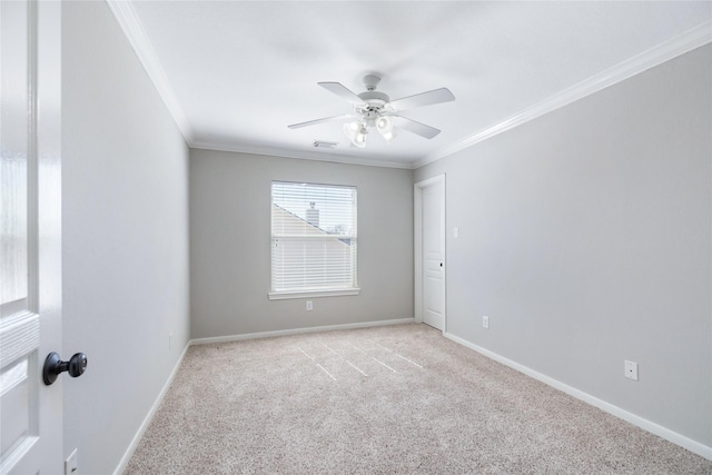 unfurnished room with baseboards, light colored carpet, visible vents, and ornamental molding