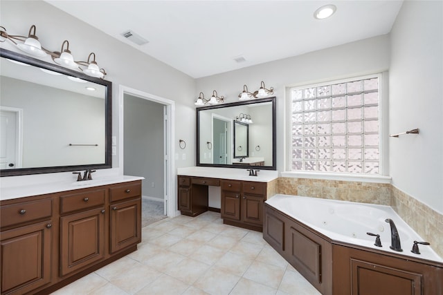 full bathroom featuring visible vents, a jetted tub, two vanities, tile patterned floors, and a sink