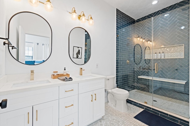 bathroom with tile patterned floors, toilet, vanity, and walk in shower