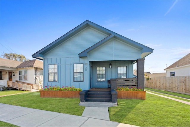 view of front of house with a porch and a front lawn