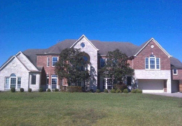 view of front of house with a garage and a front yard