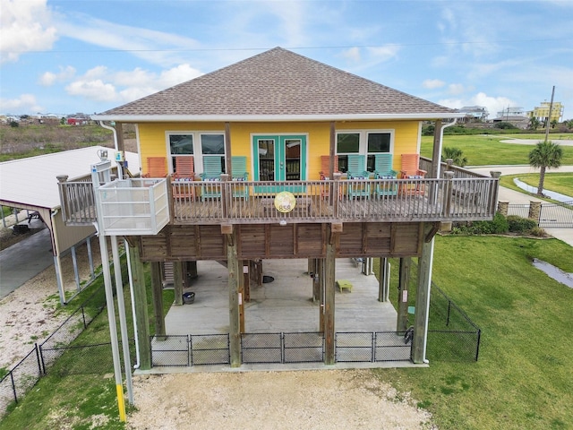 back of house with a carport and a deck