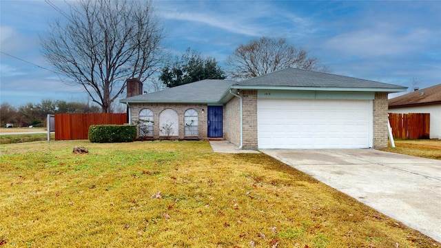 single story home with a garage and a front lawn