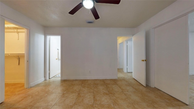 tiled empty room with ceiling fan