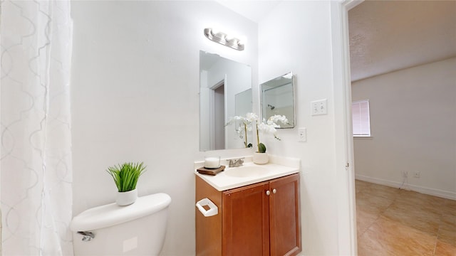 bathroom featuring vanity, a textured ceiling, and toilet