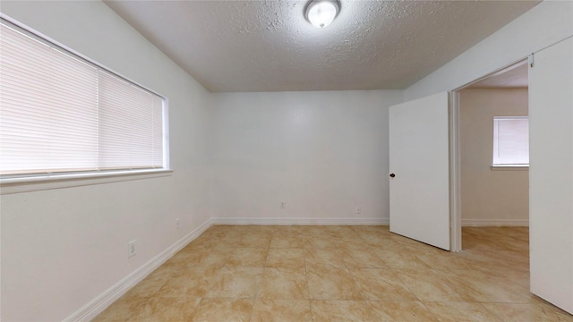 spare room featuring a textured ceiling