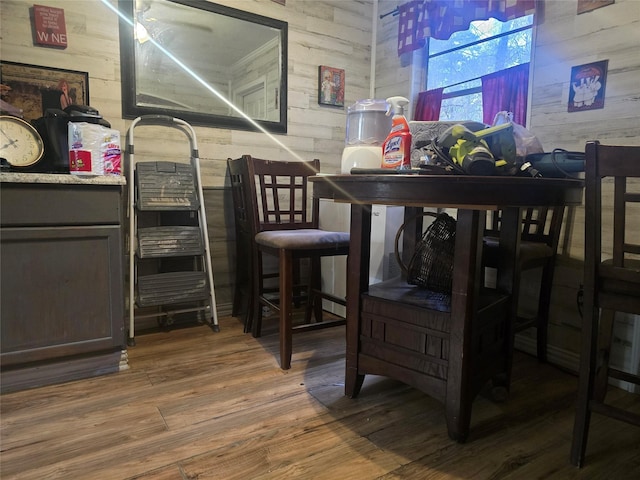 bar with dark wood-type flooring and wood walls