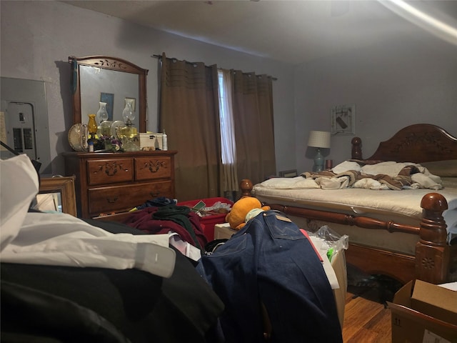 bedroom with hardwood / wood-style flooring and electric panel