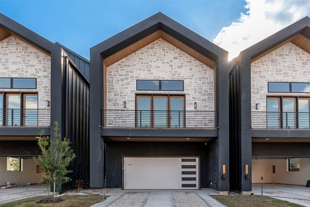 view of front of property with a garage and a balcony