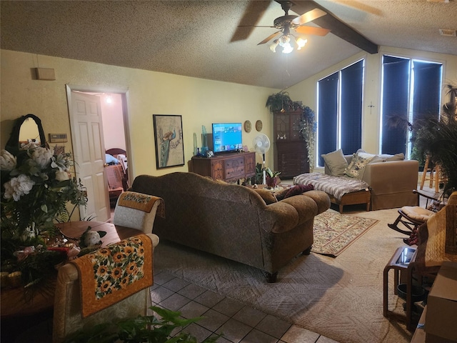 living room with vaulted ceiling with beams, tile patterned floors, a textured ceiling, and ceiling fan