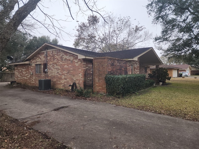 view of home's exterior with central AC and a lawn