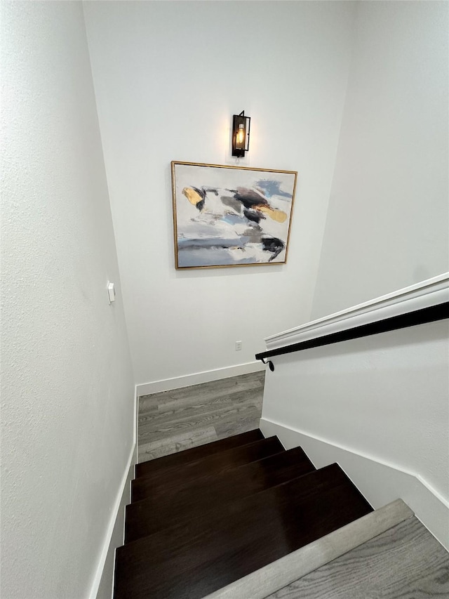 stairway featuring wood-type flooring