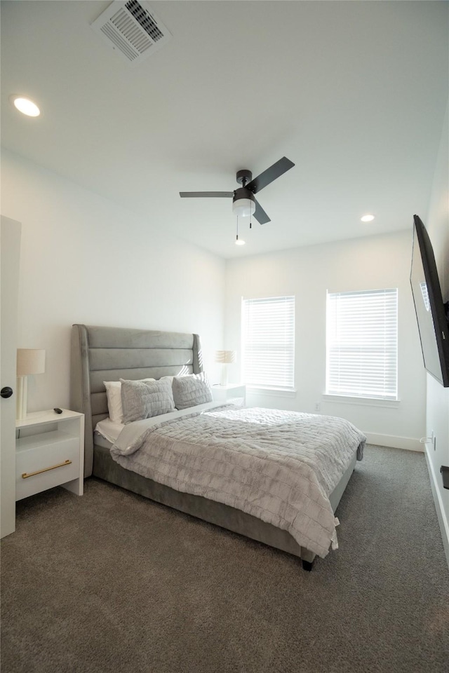 bedroom with ceiling fan and dark colored carpet