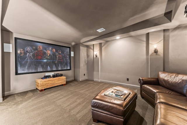 carpeted home theater room featuring visible vents and baseboards