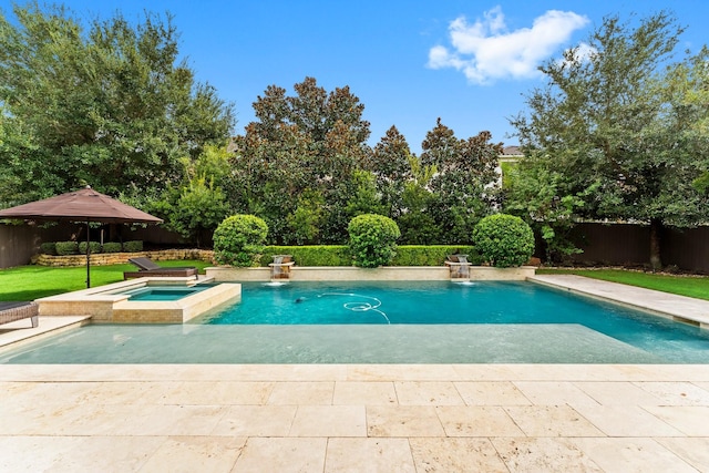 view of swimming pool with a pool with connected hot tub and a fenced backyard