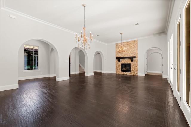 unfurnished living room featuring visible vents, baseboards, dark wood finished floors, crown molding, and a notable chandelier