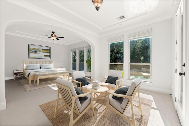 bedroom featuring arched walkways, visible vents, crown molding, and multiple windows