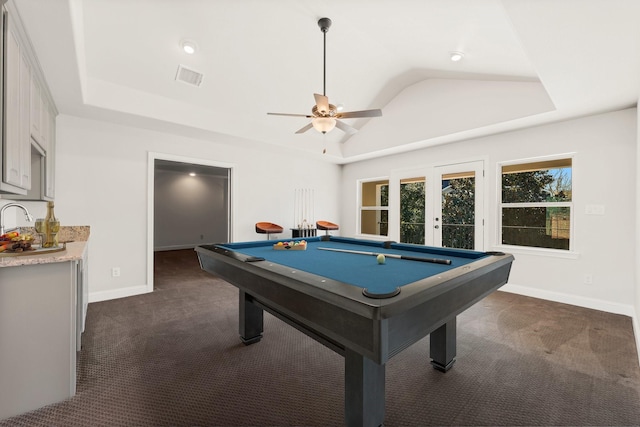 playroom featuring a tray ceiling, visible vents, and dark colored carpet