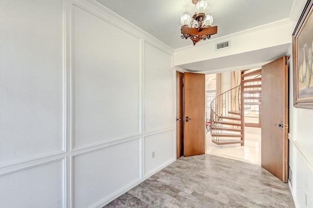 hall featuring ornamental molding and a notable chandelier