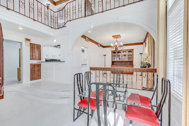 dining room featuring ornamental molding and a chandelier