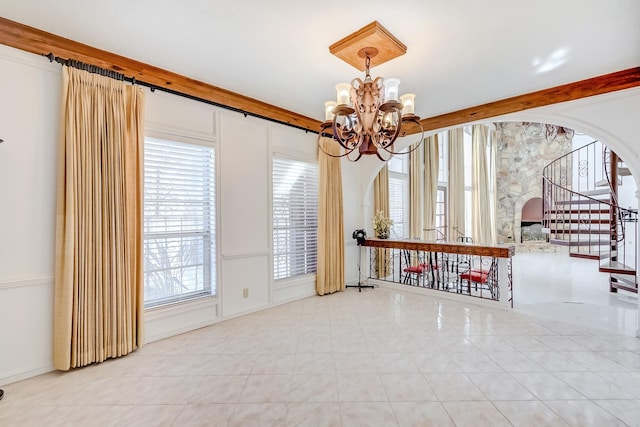 interior space featuring light tile patterned floors and an inviting chandelier