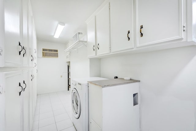 laundry area featuring cabinets, washer / clothes dryer, and light tile patterned floors