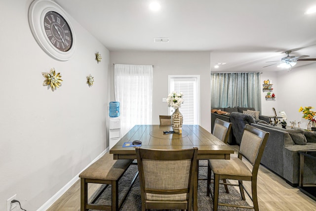 dining space with light hardwood / wood-style floors and ceiling fan