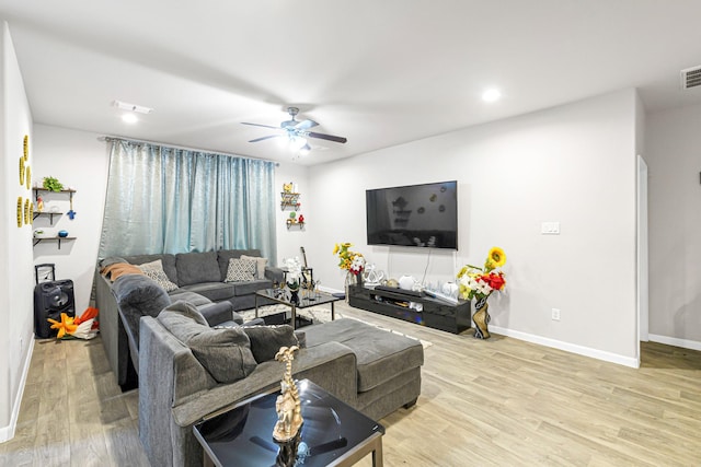 living room with ceiling fan and light wood-type flooring