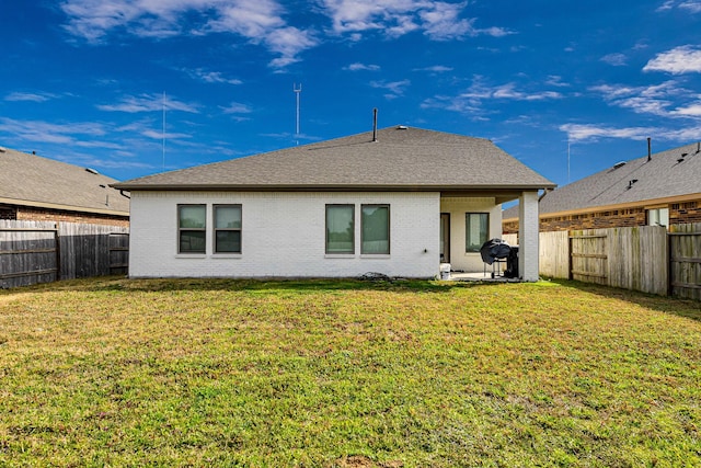 rear view of house featuring a lawn