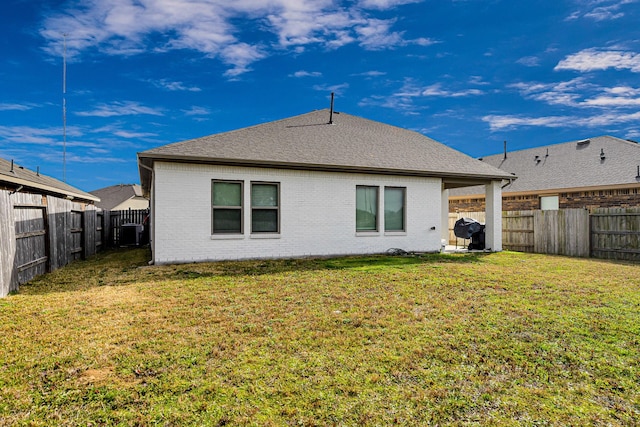 rear view of property featuring a yard