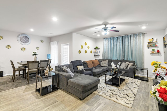 living room featuring light hardwood / wood-style floors and ceiling fan