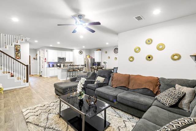 living room with ceiling fan and light hardwood / wood-style floors