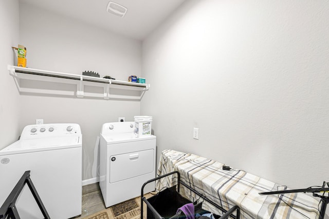 laundry room featuring wood-type flooring and washer and dryer