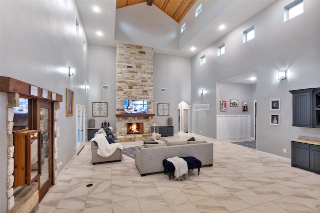 living room with a fireplace and a high ceiling