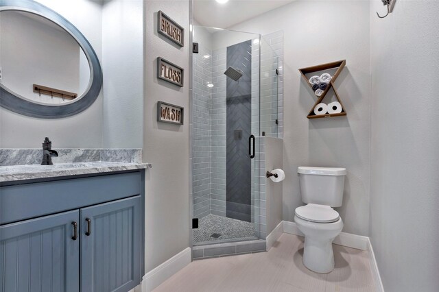 bathroom featuring vanity, an enclosed shower, tile patterned floors, and toilet